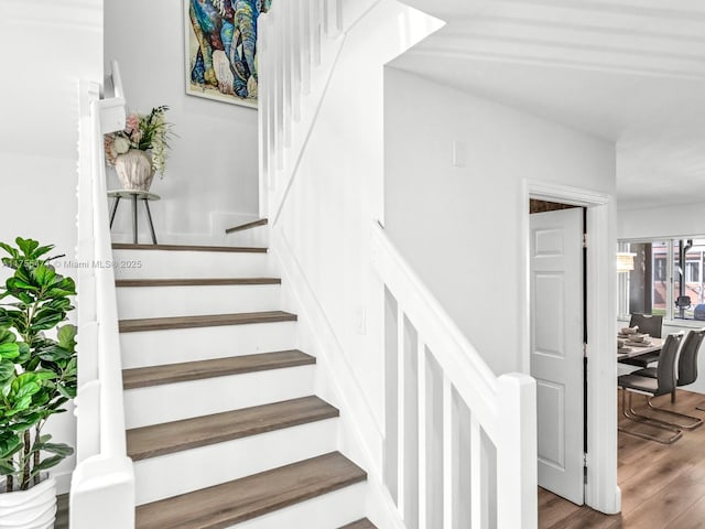 stairway featuring wood finished floors