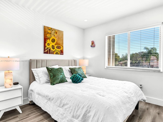 bedroom featuring baseboards and wood finished floors