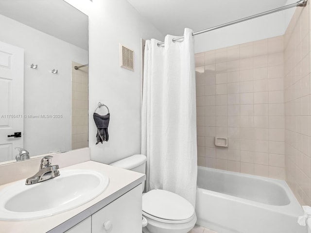 bathroom featuring visible vents, vanity, toilet, and shower / bath combo with shower curtain