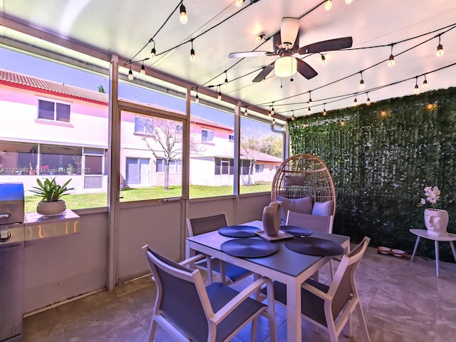 sunroom / solarium with track lighting and a ceiling fan