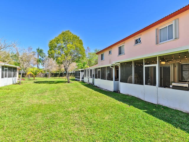 view of yard with a sunroom