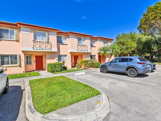 multi unit property with uncovered parking and stucco siding