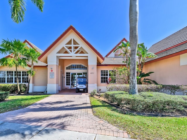 view of building exterior featuring decorative driveway