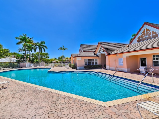 pool featuring a patio and fence