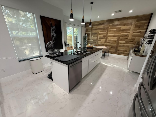 kitchen featuring dark countertops, visible vents, marble finish floor, and wood walls