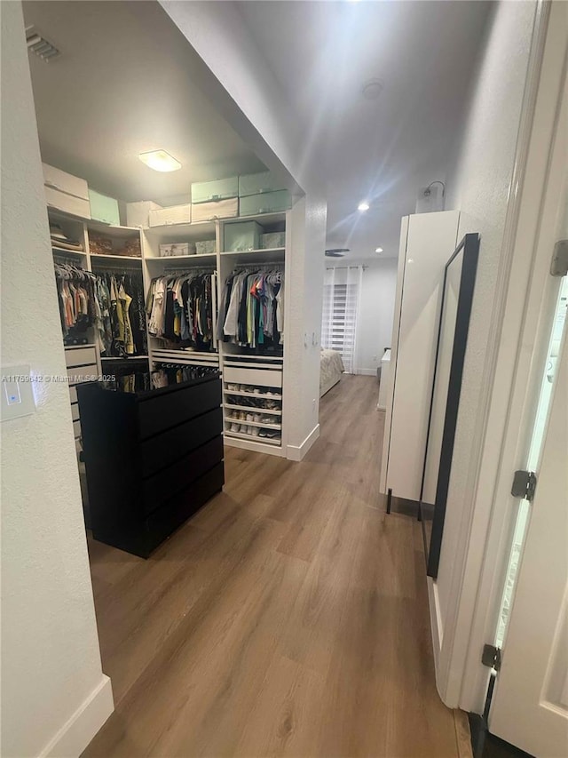 walk in closet with visible vents and wood finished floors