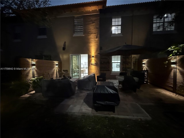 rear view of house featuring a patio and an outdoor hangout area