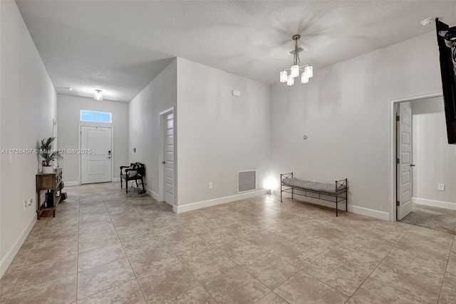 5338 Lugo St, Fort Pierce, FL 34951 - entrance foyer featuring visible vents, an inviting chandelier, and baseboards
