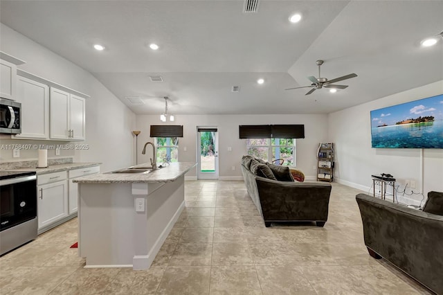 5338 Lugo St, Fort Pierce, FL 34951 - kitchen with a sink, visible vents, appliances with stainless steel finishes, and vaulted ceiling