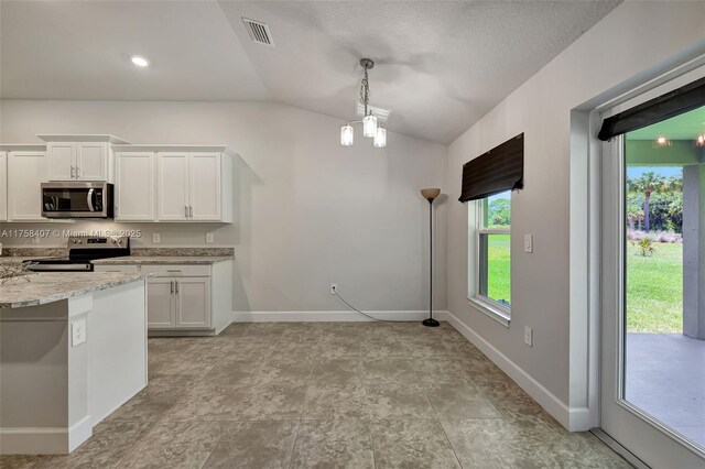 5338 Lugo St, Fort Pierce, FL 34951 - kitchen with visible vents, appliances with stainless steel finishes, white cabinets, baseboards, and vaulted ceiling