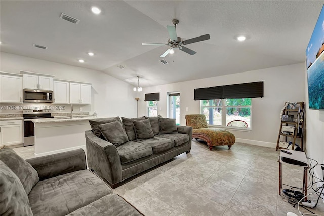 5338 Lugo St, Fort Pierce, FL 34951 - living room featuring visible vents, ceiling fan, and vaulted ceiling
