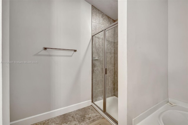 5338 Lugo St, Fort Pierce, FL 34951 - bathroom with a tub, baseboards, and a stall shower