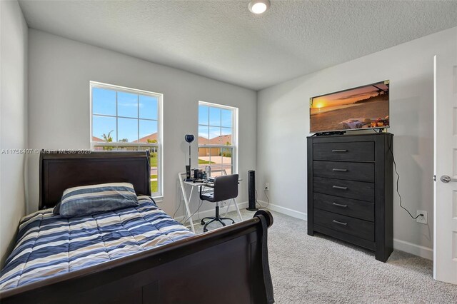 5338 Lugo St, Fort Pierce, FL 34951 - bedroom with light colored carpet, baseboards, and a textured ceiling