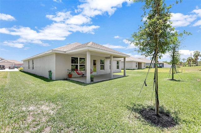 5338 Lugo St, Fort Pierce, FL 34951 - rear view of property featuring a patio area, a lawn, roof with shingles, and stucco siding