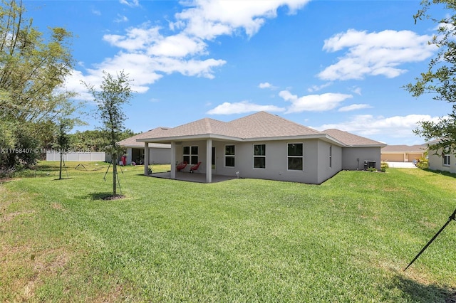 5338 Lugo St, Fort Pierce, FL 34951 - rear view of house with a yard, a patio, stucco siding, and fence