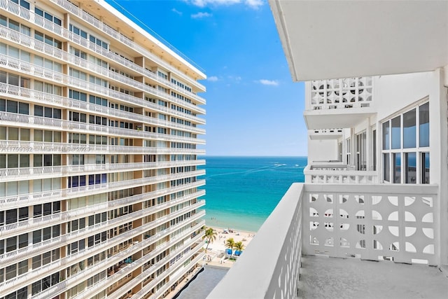 balcony with a beach view and a water view