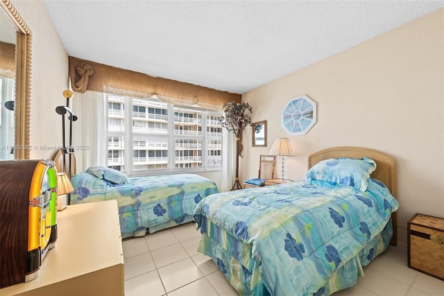 bedroom with tile patterned flooring and a textured ceiling