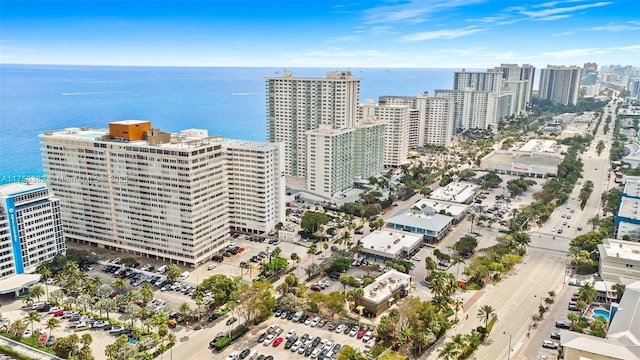 birds eye view of property with a view of city and a water view