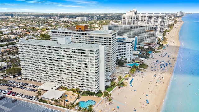 birds eye view of property featuring a city view, a beach view, and a water view