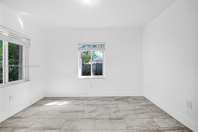 spare room with baseboards