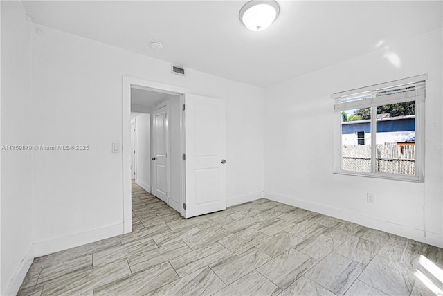 empty room featuring visible vents and baseboards