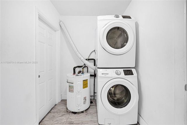 washroom featuring laundry area, electric water heater, and stacked washing maching and dryer