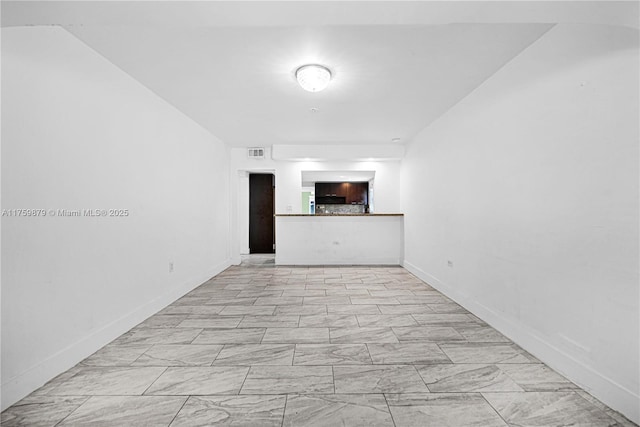 spare room featuring visible vents and baseboards