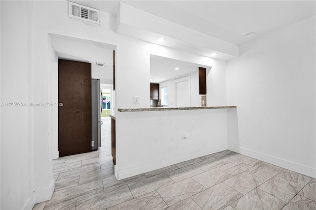 kitchen featuring recessed lighting, visible vents, baseboards, and freestanding refrigerator
