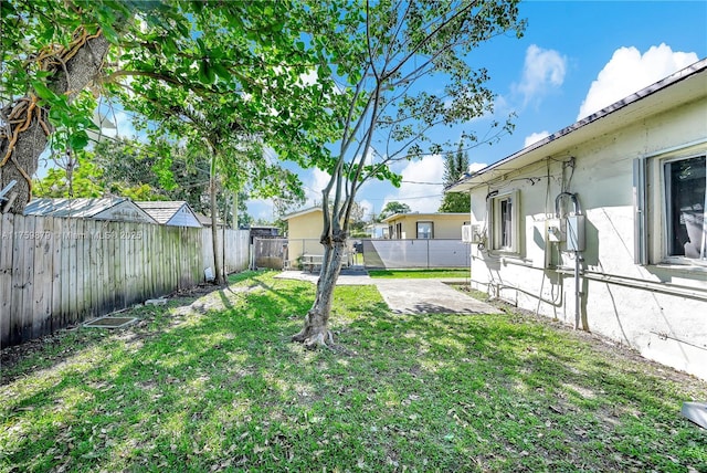 view of yard with a patio and a fenced backyard