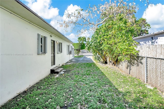 view of yard with entry steps and fence