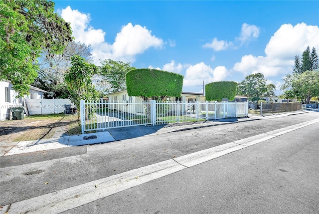 view of gate with a fenced front yard