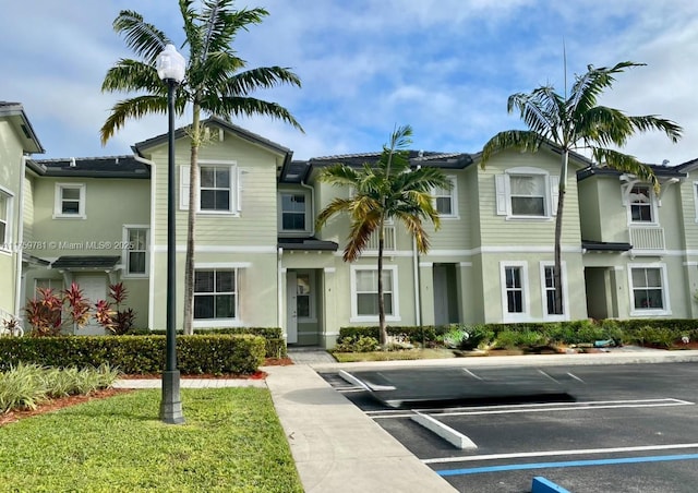 view of property featuring uncovered parking