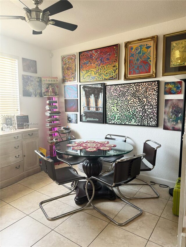 tiled dining area featuring ceiling fan