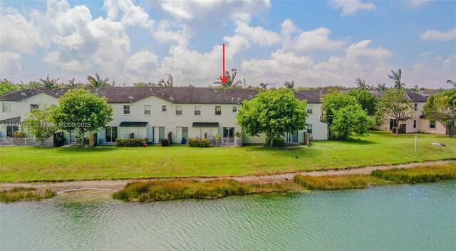 2853 SE 1st Dr Unit 4, Homestead, FL 33033 - back of property with a residential view, a lawn, a water view, and stucco siding