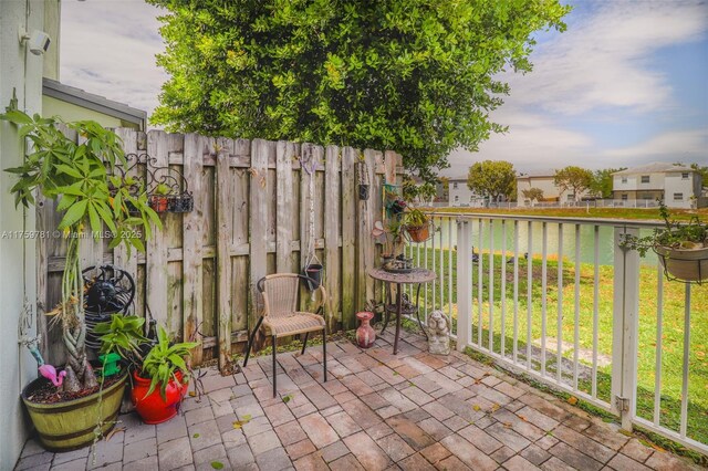 2853 SE 1st Dr Unit 4, Homestead, FL 33033 - view of patio with a water view and fence