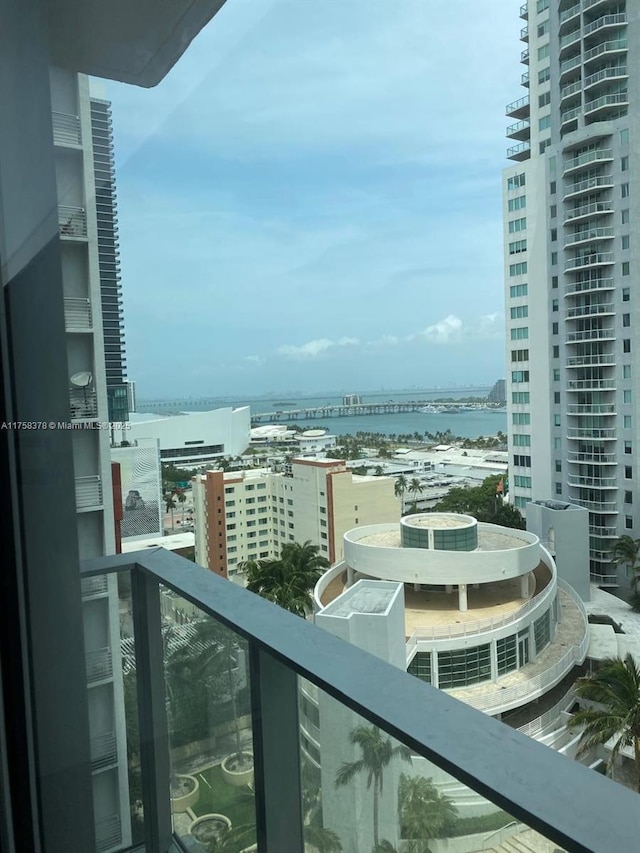 balcony featuring a city view and a water view