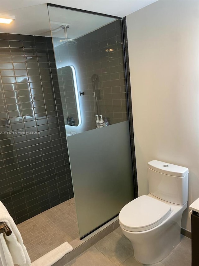 227 NE 2nd St Unit 1910, Miami, FL 33132 - bathroom featuring tile patterned floors, toilet, vanity, and a walk in shower