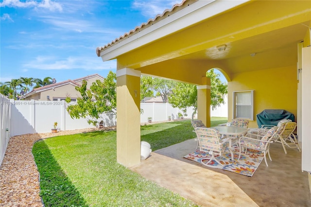 view of patio / terrace with outdoor dining space, a fenced backyard, and grilling area