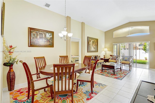 dining area featuring tile patterned flooring, vaulted ceiling, a notable chandelier, and visible vents