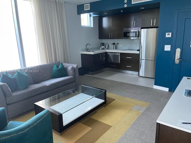 living room featuring visible vents and light colored carpet
