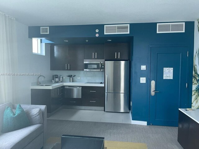kitchen featuring visible vents, stainless steel appliances, and light countertops