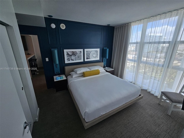 bedroom featuring multiple windows and carpet flooring