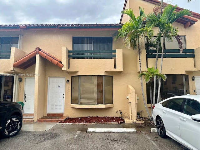 10023 SW 77th Ct, Miami, FL 33156 - view of property featuring stucco siding and uncovered parking