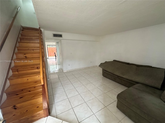 10023 SW 77th Ct, Miami, FL 33156 - living area with stairway, a textured ceiling, and light tile patterned floors