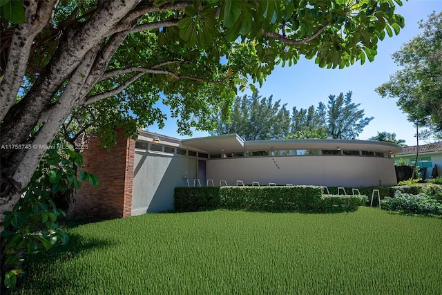 exterior space featuring a lawn and stucco siding