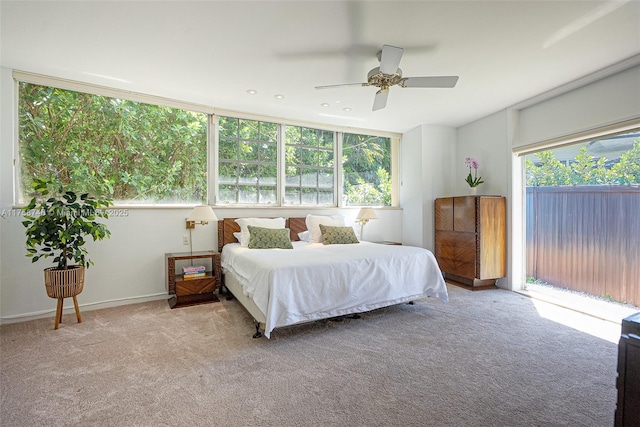 carpeted bedroom with a ceiling fan and access to outside