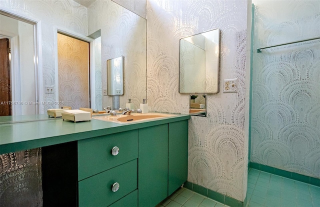 full bathroom featuring wallpapered walls, vanity, baseboards, and tile patterned flooring