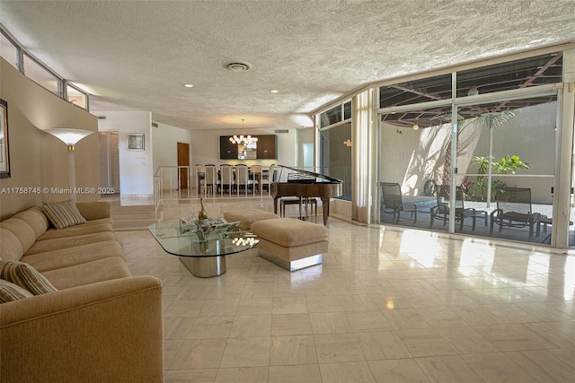 living room with a textured ceiling and an inviting chandelier