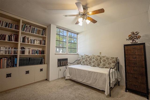 carpeted bedroom featuring heating unit and a ceiling fan