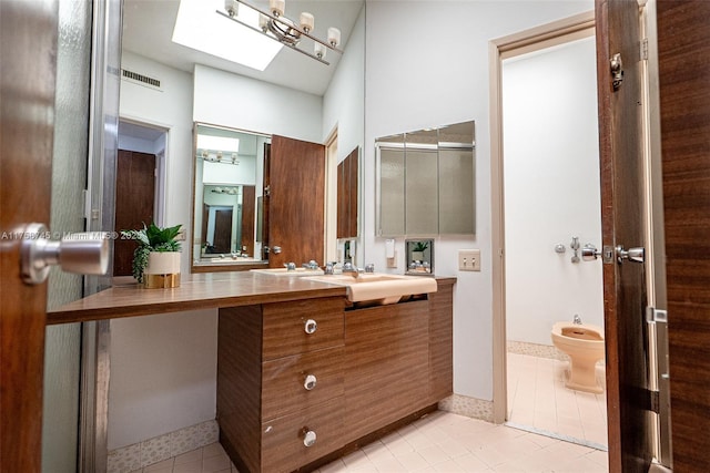 bathroom featuring vanity, a bidet, visible vents, a skylight, and tile patterned flooring